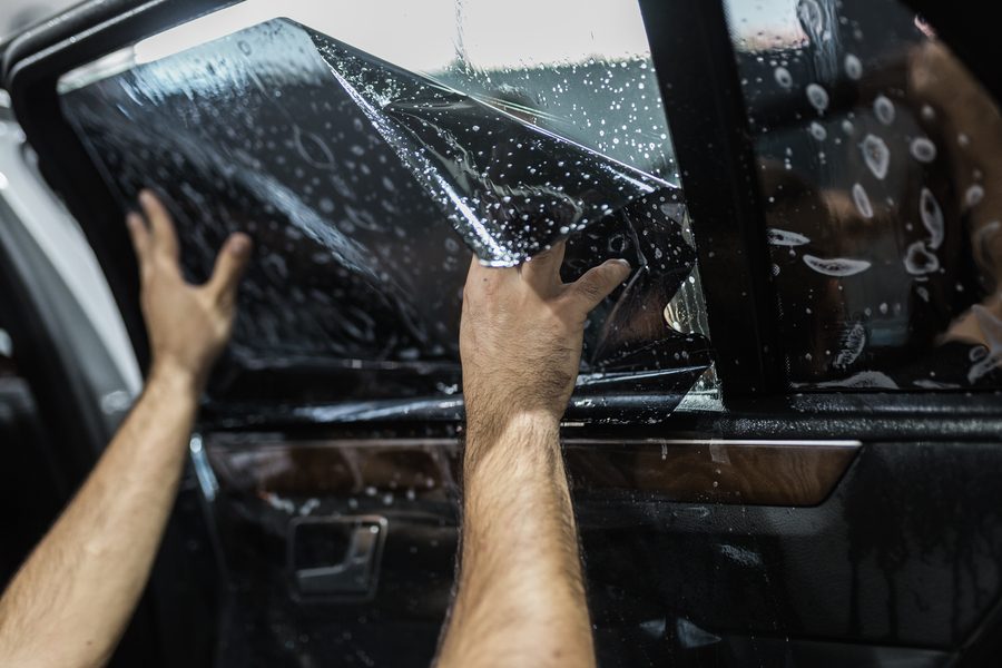 Car,Tinting,-,Worker,Applying,Tinting,Foil,On,Car,Window.